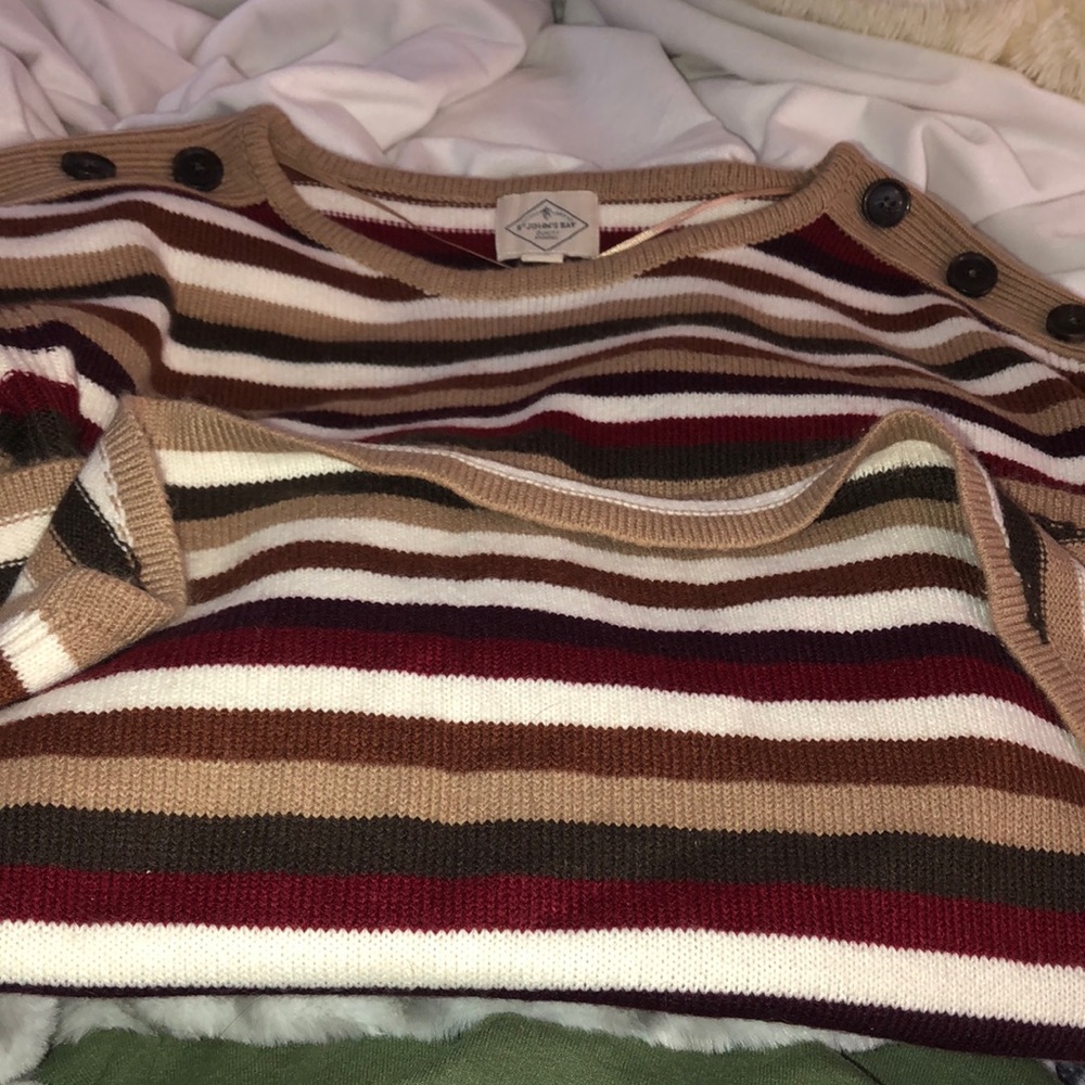 Almost new very cozy sweater. Has 3 stylish buttons on each shoulder.